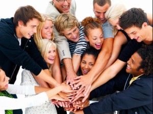 Closeup of a group of happy friends with hands on hands